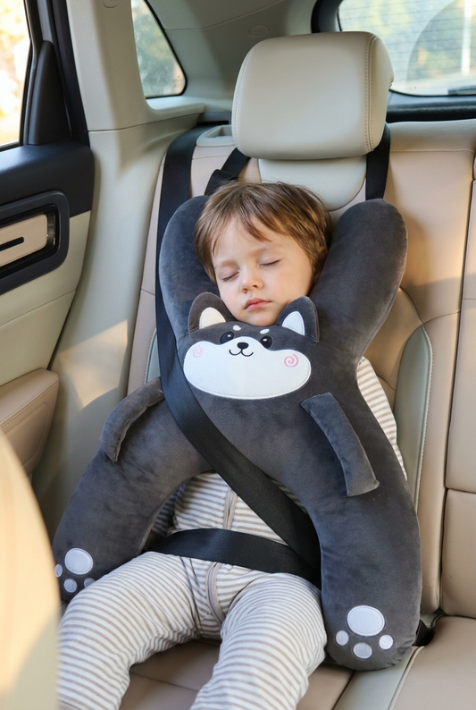 Child asleep in a car seat resting on the SnoozeCub Kid Neck Pillow, Husky